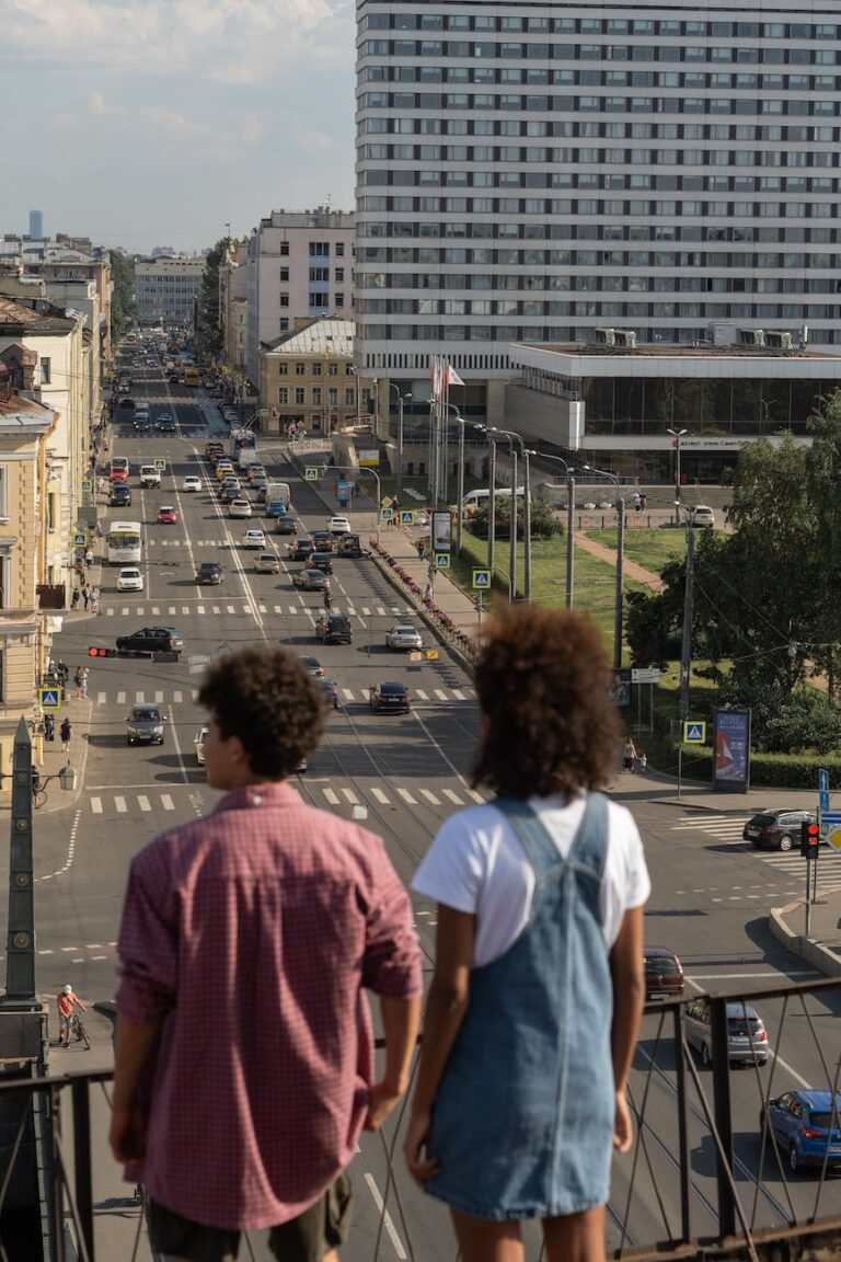 young man and woman standing on footbridge