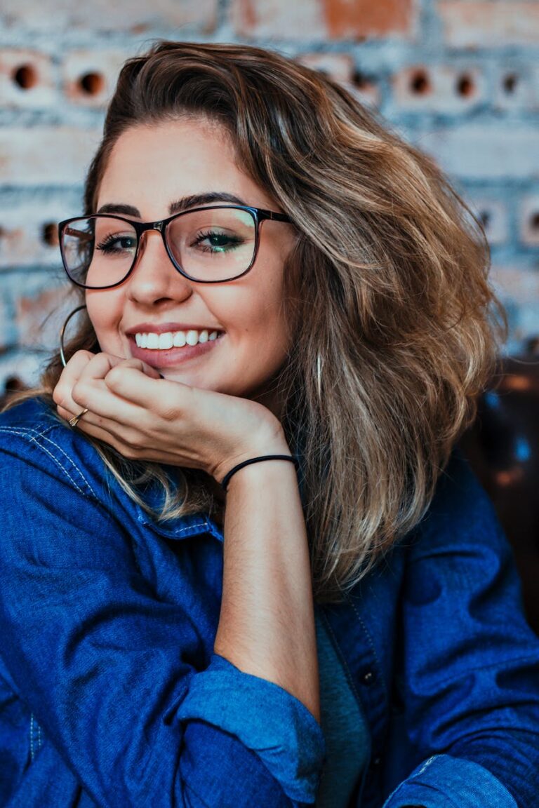 closeup photo of smiling woman wearing blue denim jacket