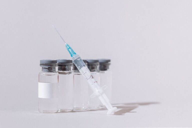 covid vaccine bottles and syringe