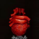 artistic gothic red heart sculpture on ornate stand