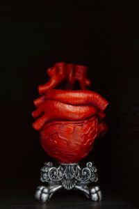artistic gothic red heart sculpture on ornate stand