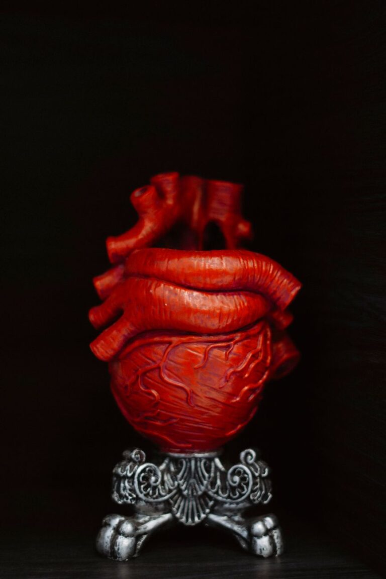 artistic gothic red heart sculpture on ornate stand