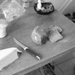 a grayscale of a table with ingredients and a knife