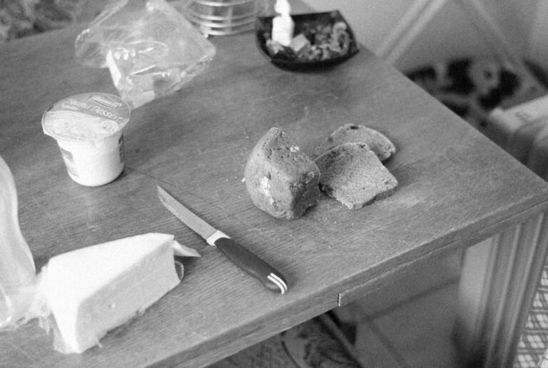 a grayscale of a table with ingredients and a knife