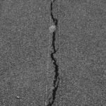close up of a cracked asphalt road surface