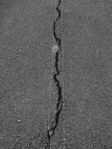 close up of a cracked asphalt road surface