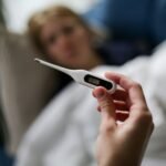 a person holding a thermometer