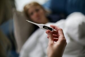 a person holding a thermometer