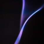 a purple flame is shown on a black background