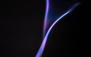a purple flame is shown on a black background