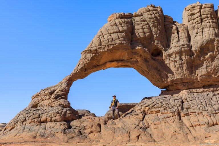 a person standing in front of a rock formation
