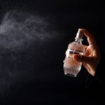 elegant perfume bottle spritzed in dark setting