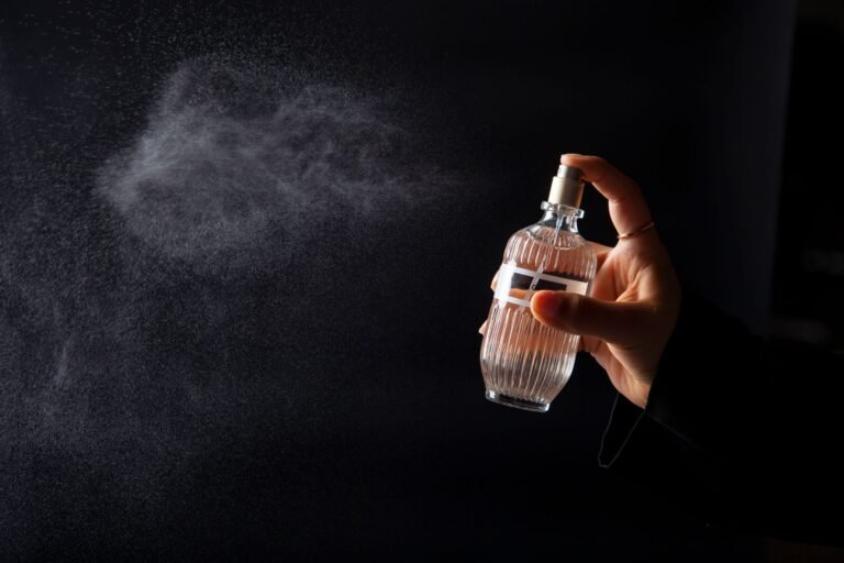 elegant perfume bottle spritzed in dark setting