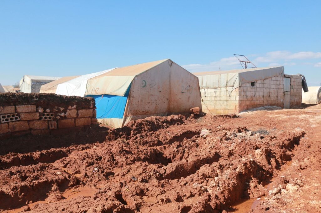 shabby tents and brick weathered houses in poor settlement