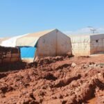 shabby tents and brick weathered houses in poor settlement