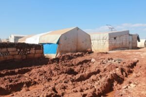 shabby tents and brick weathered houses in poor settlement