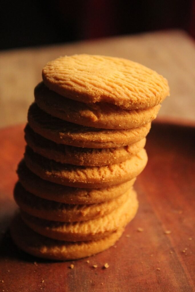 stack of homemade shortbread cookies on wooden board