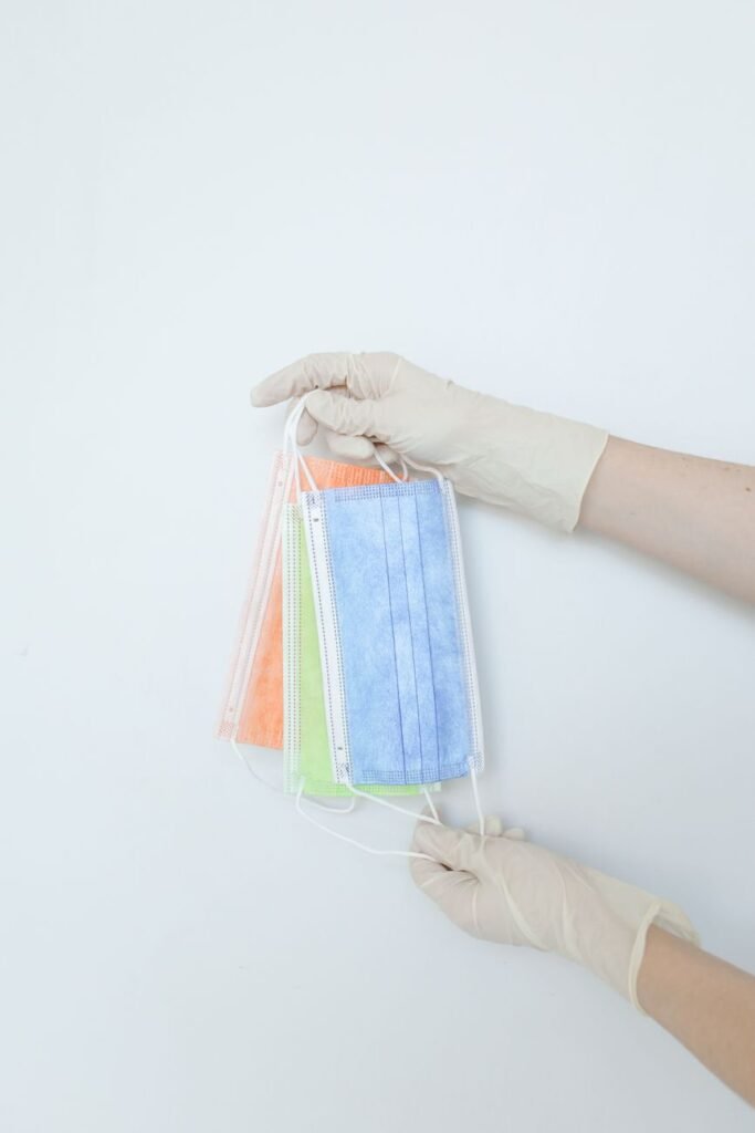 hands of a person holding disposable face masks